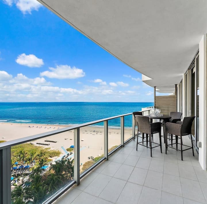 The residence balcony overlooking the beach and turquoise water